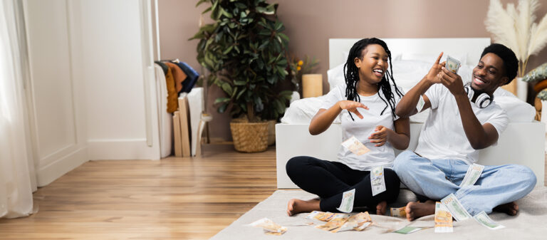 couple laughing sitting on floor