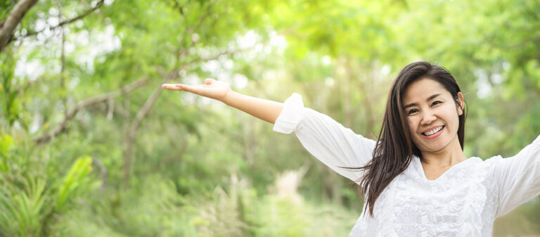 carefree girl with arms in the air